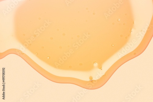 Cream gel yellow orange transparent cosmetic sample texture with bubbles isolated background