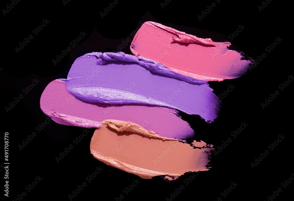 Fototapeta premium Red pink orange purple pastel lipstick black background texture smudged