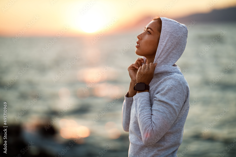 Woman Enjoying Summer Sunset And Relaxing After Training Near The Sea Woman Enjoying Summer Sunset And Relaxing After Training Near The Sea