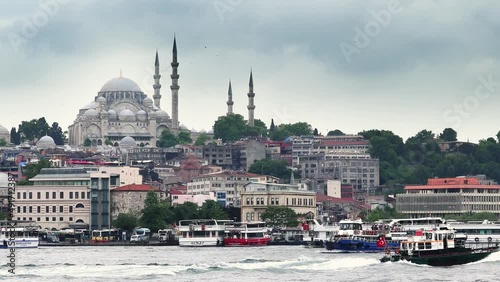 View of the Suleymaniye Mosque and fishing boats in Eminonu, Istanbul, Turkey photo