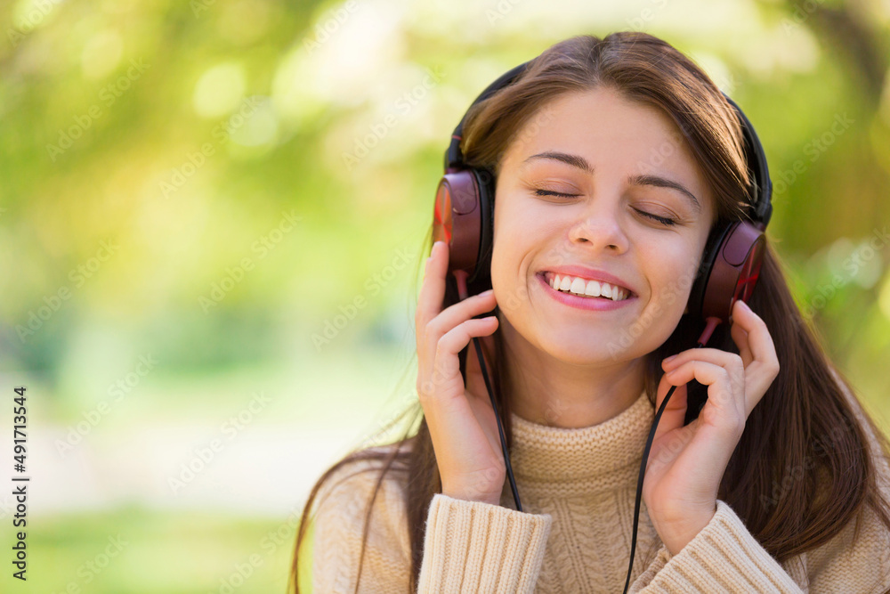 Lost in nature and the music. An attractive young woman listening to music outdoors. Lost in nature and the music. An attractive young woman listening to music outdoors.
