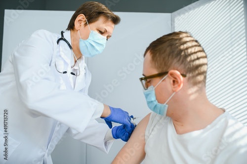 Female doctor vaccinating a man