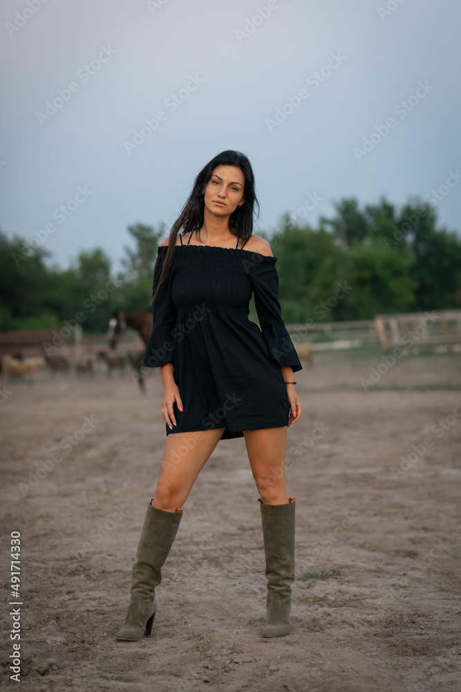 Girl with long black hair in the countryside. Ipadrome with horses. Rural landscapes, wild west. Girl with long black hair in the countryside. Ipadrome with horses. Rural landscapes, wild west.