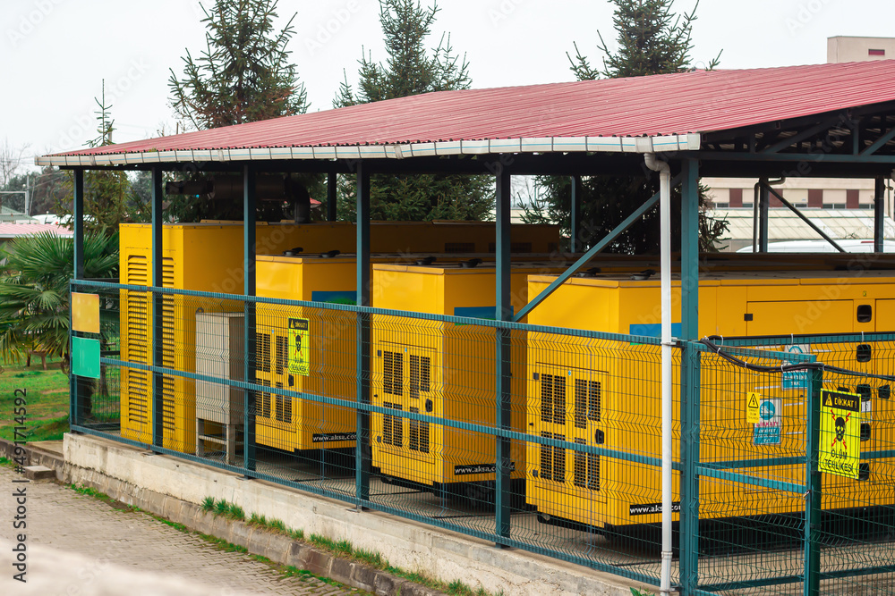 Industrial electric generator for electric power in cage with roof Industrial electric generator for electric power in cage with roof