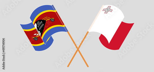 Crossed and waving flags of Malta and Eswatini