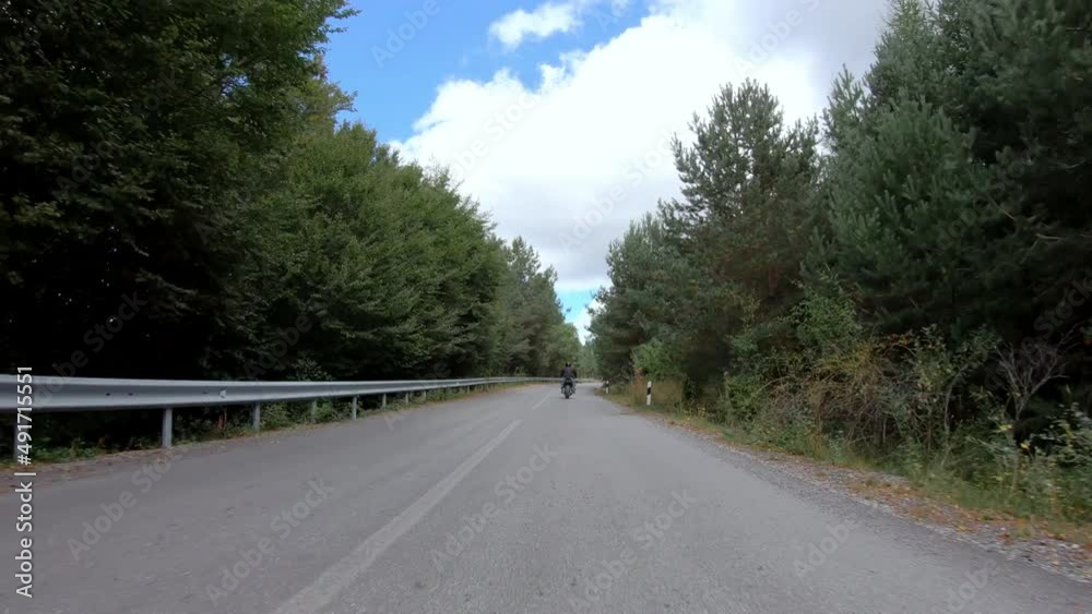 Fast motorcycle stunt road riding. having fun driving dangerous wheelie on mountain rural road Fast motorcycle stunt road riding. having fun driving dangerous wheelie on mountain rural road