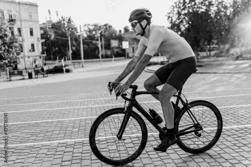 Cyclist in helmet and glasses training during free time