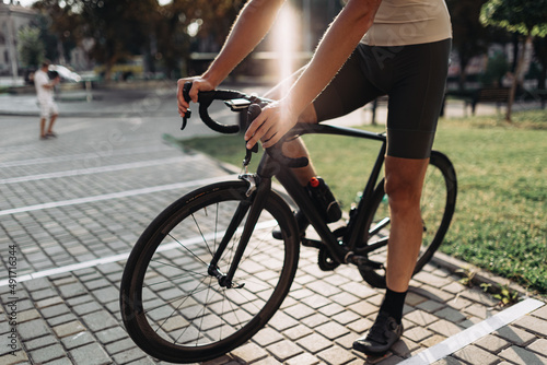 Close up of cyclist in sportswear sitting on bike outdoors