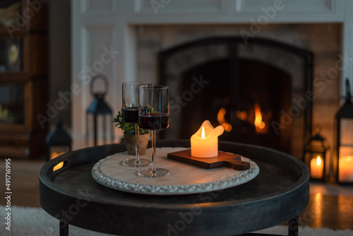 фотографія Two glasses of red wine at home by candlelight
