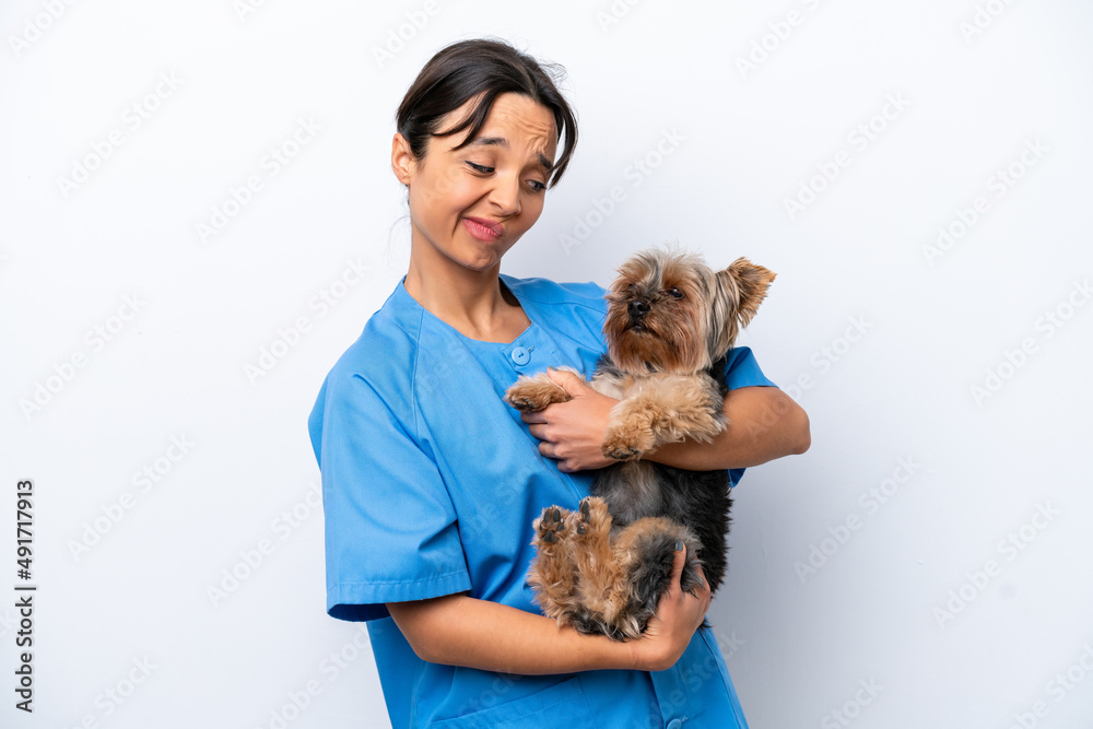 Young veterinarian woman with dog isolated on white background with sad expression Young veterinarian woman with dog isolated on white background with sad expression