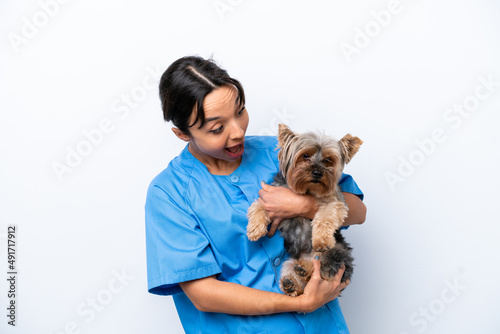 Young veterinarian woman with dog isolated on white background with surprise and shocked facial expression
