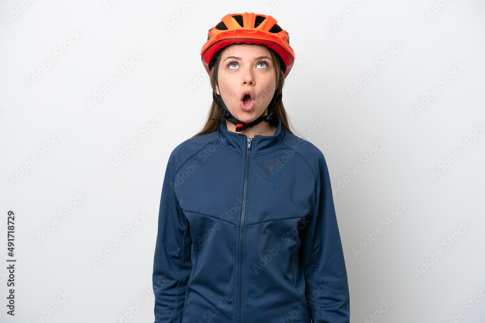 Young cyclist Lithuanian woman isolated on white background looking up and with surprised expression Young cyclist Lithuanian woman isolated on white background looking up and with surprised expression
