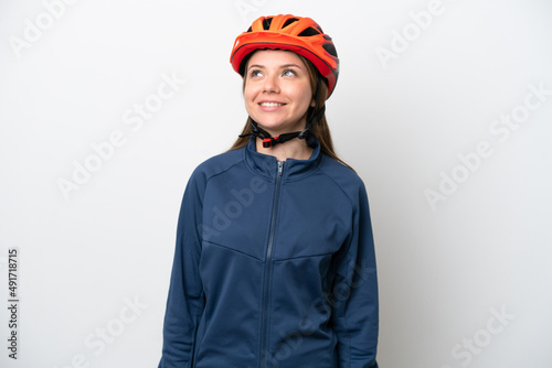 Young cyclist Lithuanian woman isolated on white background thinking an idea while looking up
