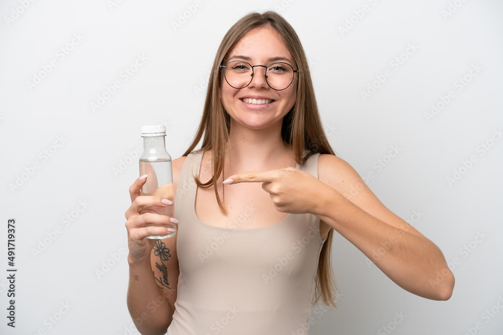 Young Lithuanian woman with a bottle of water isolated on white background and pointing it Young Lithuanian woman with a bottle of water isolated on white background and pointing it