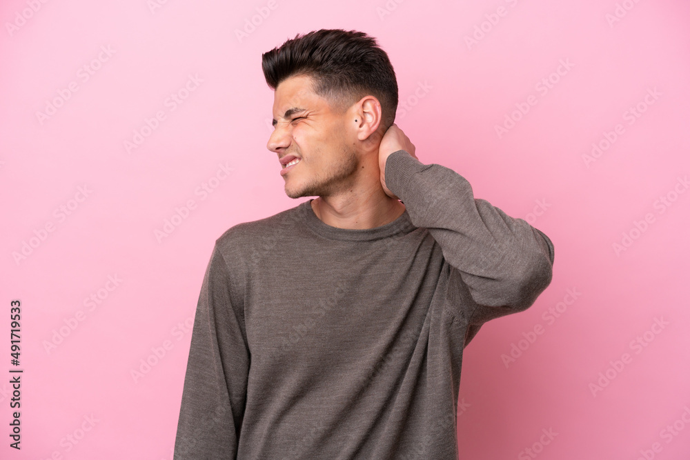 Young caucasian man isolated on pink background with neckache Young caucasian man isolated on pink background with neckache