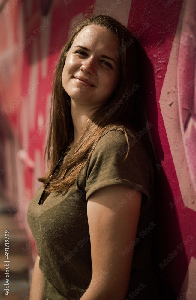 Portrait shot of a pretty girl in the streets against a colorful wall - street style photography - travel photography Portrait shot of a pretty girl in the streets against a colorful wall - street style photography - travel photography
