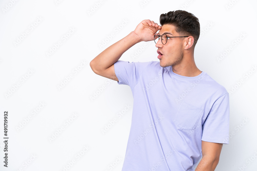 Young caucasian man isolated on white background with surprise expression while looking side Young caucasian man isolated on white background with surprise expression while looking side