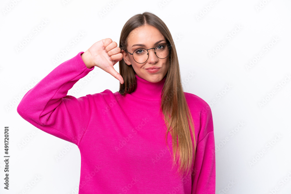 Young caucasian woman isolated on white background showing thumb down with negative expression