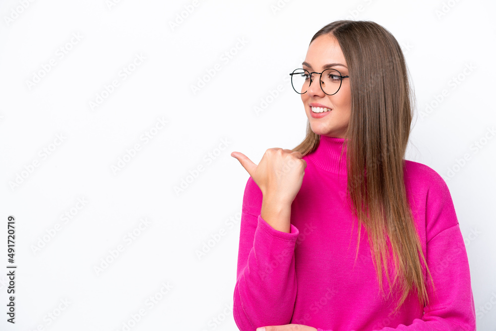 Young caucasian woman isolated on white background pointing to the side to present a product