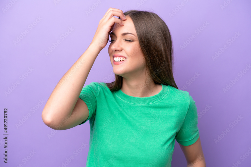 Young caucasian woman isolated on purple background smiling a lot