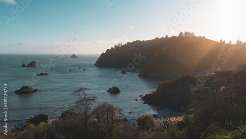 Overlooking the crisp northern Oregon coastline on a beautiful spring day while the sea shimmers and the sun shines with a warm glowing light 