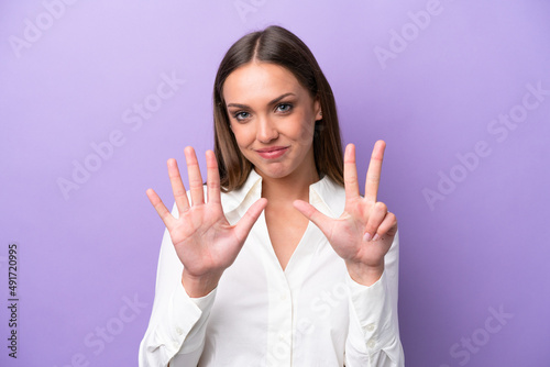 Young caucasian woman isolated on purple background counting eight with fingers