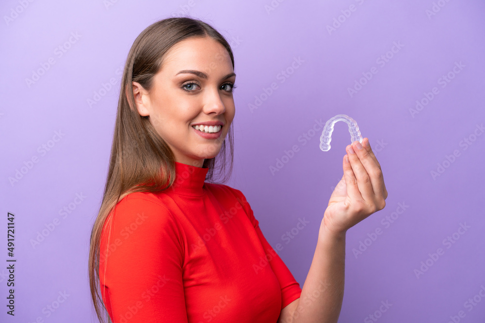 Young caucasian woman holding invisible braces smiling a lot Young caucasian woman holding invisible braces smiling a lot