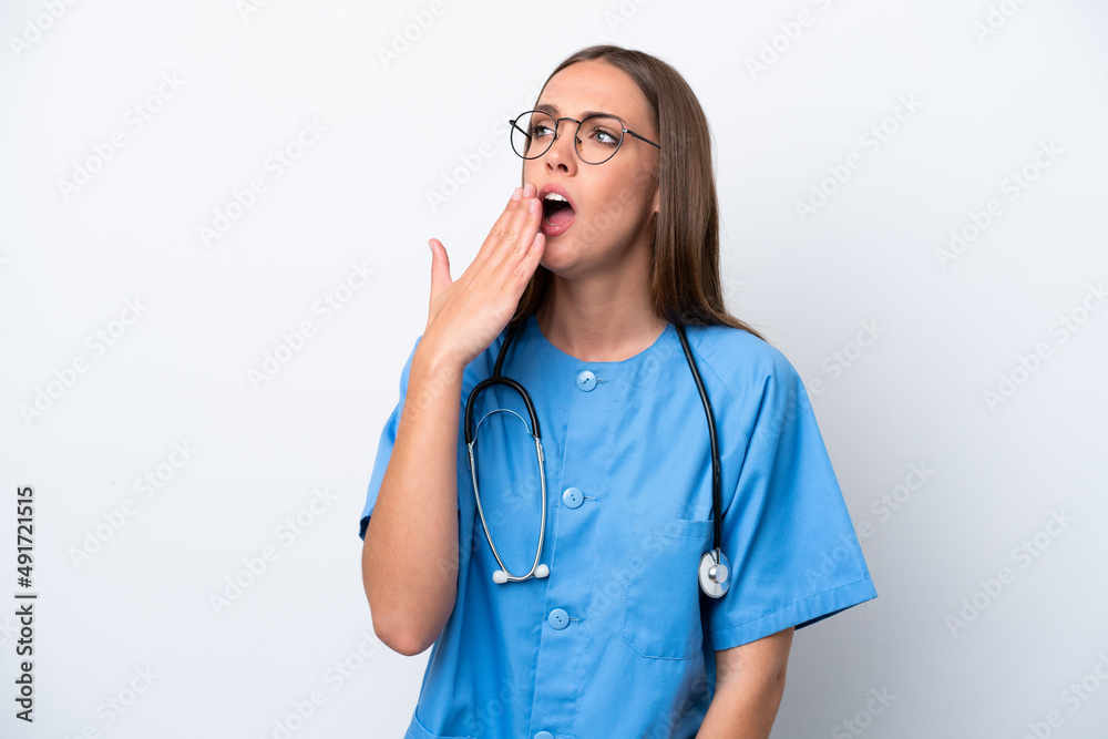 Young nurse caucasian woman isolated on white background yawning and covering wide open mouth with hand Young nurse caucasian woman isolated on white background yawning and covering wide open mouth with hand