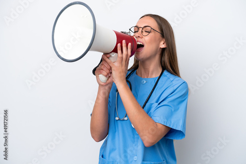 Young nurse caucasian woman isolated on white background shouting through a megaphone