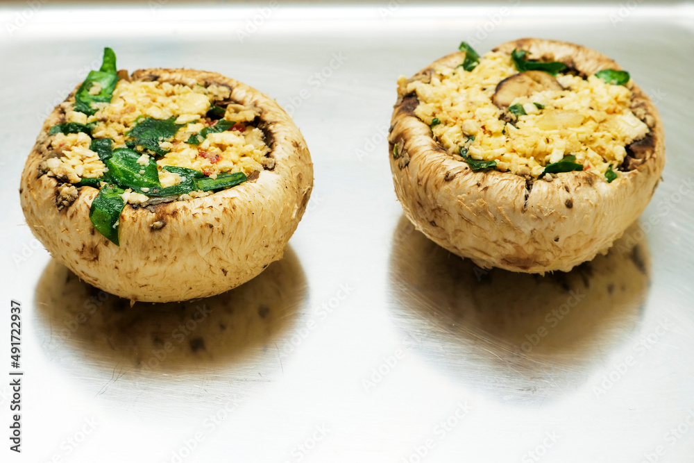 Fototapeta premium Stuffed mushrooms on a metal tray. Food industry product.