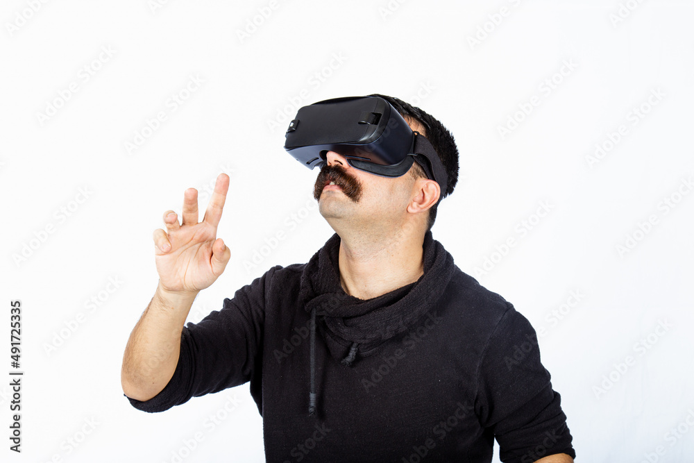 Man is pointing the space and shocking cyber realm during virtual reality experience. Man is pointing the space and shocking cyber realm during virtual reality experience.