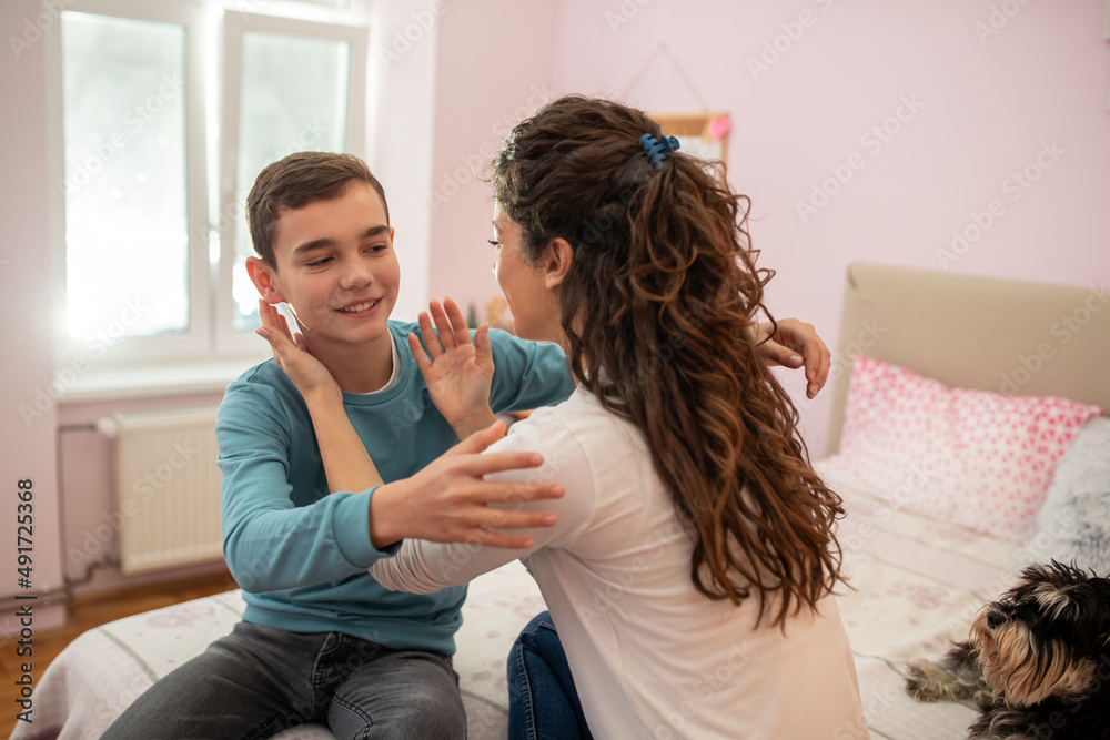 Mother and son spending quality time together cuddling and talking. Mother and son spending quality time together cuddling and talking.