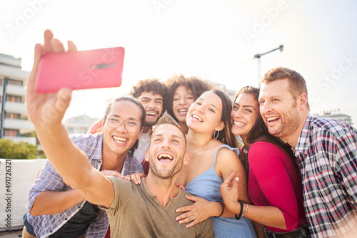 Selfie of happy group of young friends having fun together in a summer day. photo