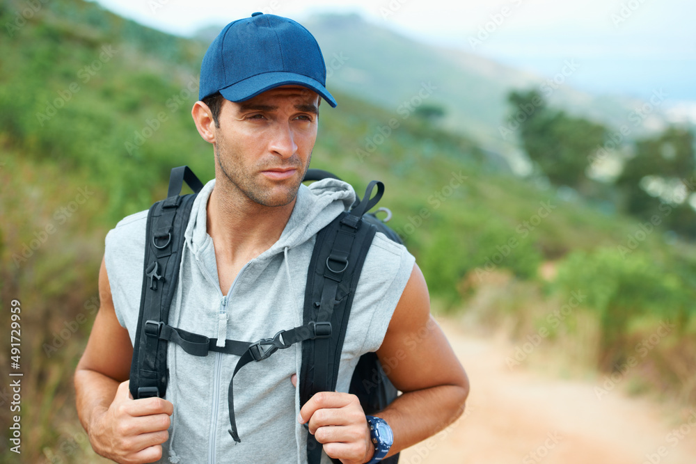 Carrying on down the road.... Young hiker wearing a backpack looking sideways. Carrying on down the road.... Young hiker wearing a backpack looking sideways.