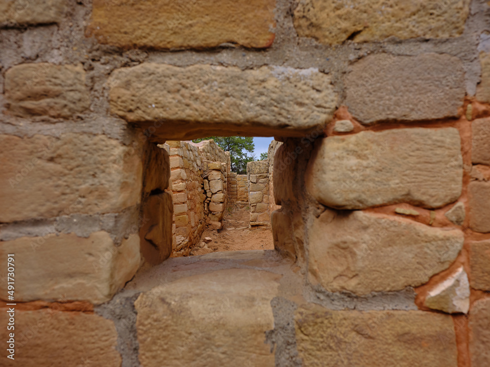 Adobe and stone structures looking in through what was a window in Mesa Verde Colorado