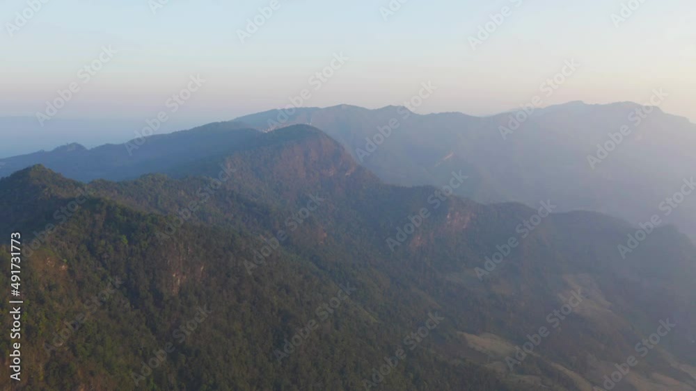 Aerial top view of forest trees and green mountain hills with fog, mist and clouds. Nature landscape background, Thailand. Aerial top view of forest trees and green mountain hills with fog, mist and clouds. Nature landscape background, Thailand.