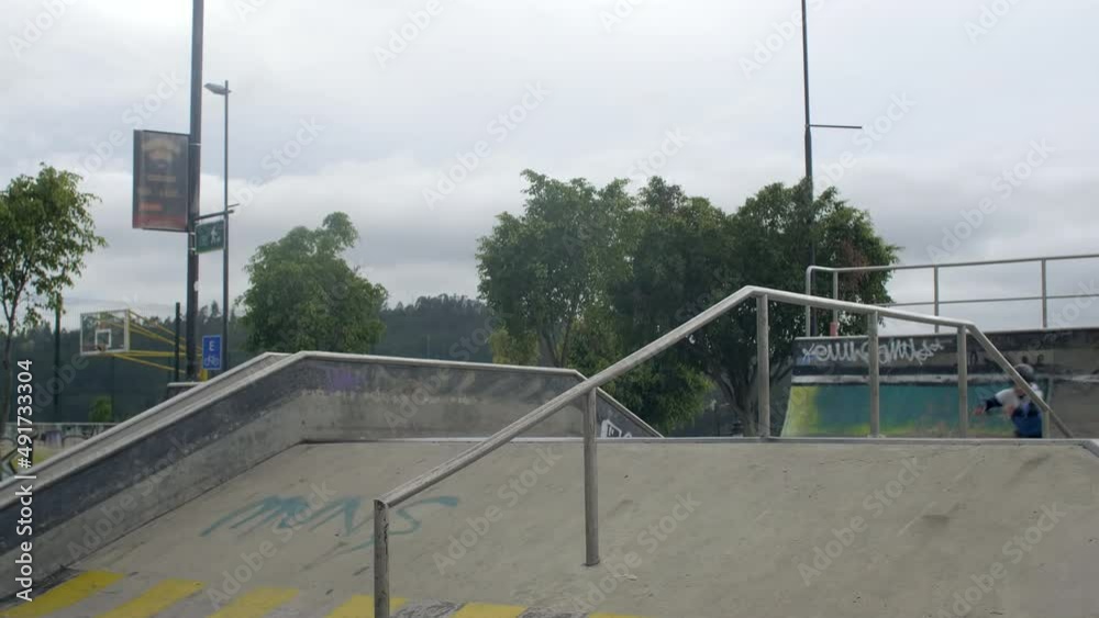 three males jumps and spins at skatepark three males jumps and spins at skatepark