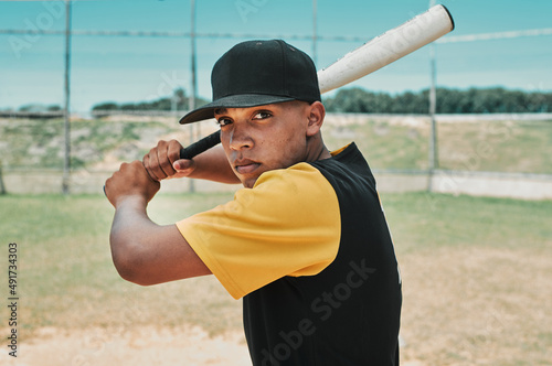 Its time to hit hard and run fast. Shot of a young baseball player holding a baseball bat while posing outside on the pitch.