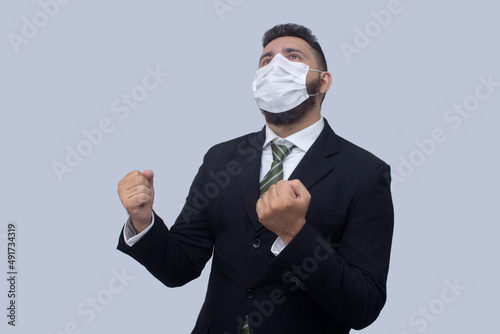 isolated businessman using mask to protect himself from viruses