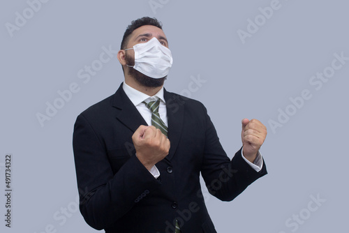 isolated businessman using mask to protect himself from viruses