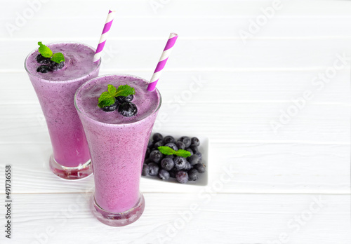 Blueberry Juice smoothies drink in a glass drink purple colorful fruit juice milkshake blend beverage healthy high protein the taste yummy in glass on white wood background.
