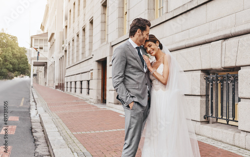 I married the one I cant go without. Shot of a beautiful couple out in the city on their wedding day.