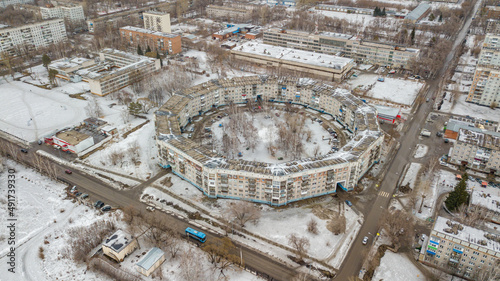 An old round residential building in Novokuznetsk in winter