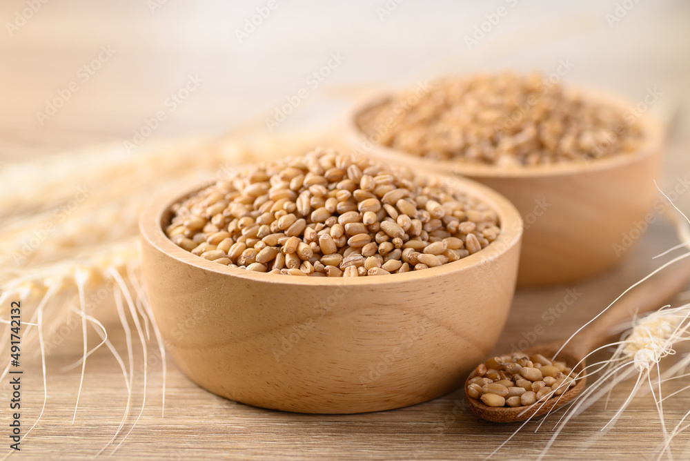 Whole wheat grain in wooden bowl, Food ingredients Whole wheat grain in wooden bowl, Food ingredients