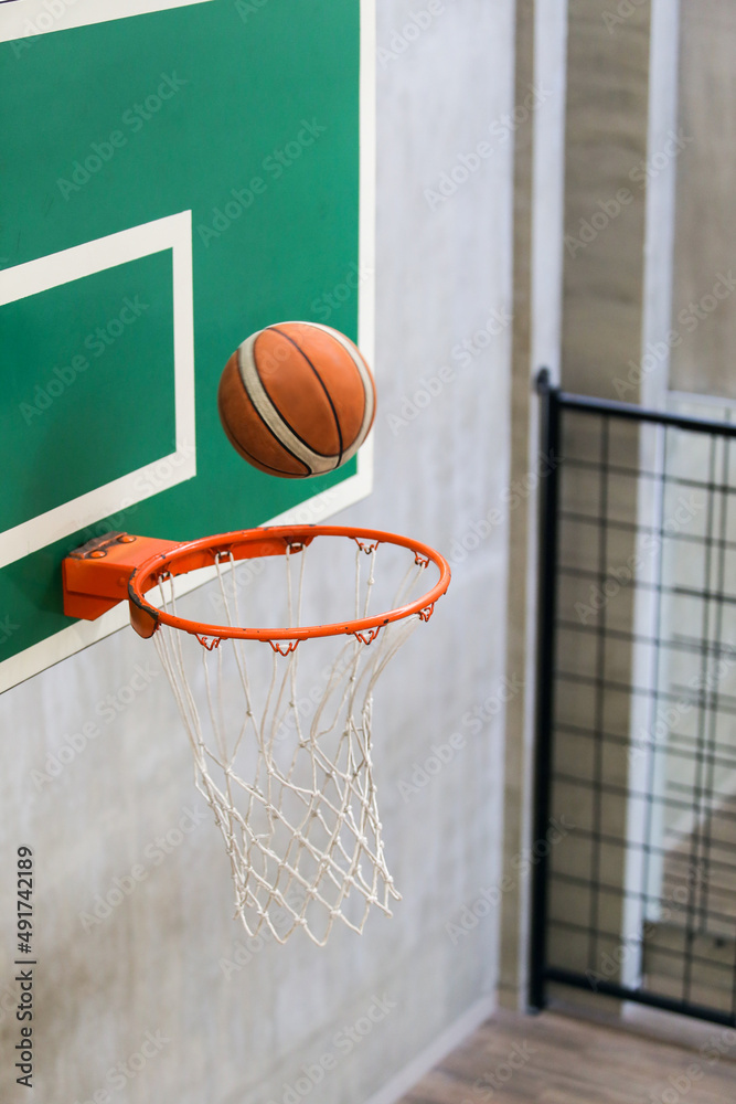 Good basketball throw. Basketball ball flies into a basketball hoop. Outdoor basketball court with ring