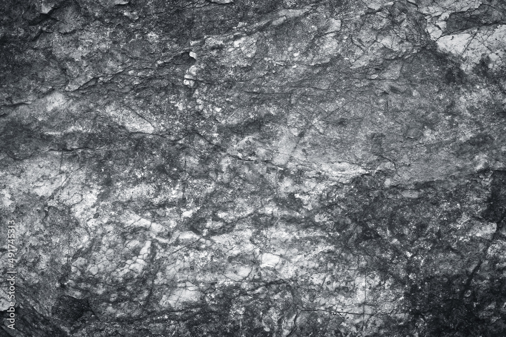Grey granite stone wall texture with natural patterns on background