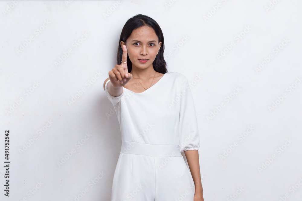 beautiful young woman with open hand doing stop sign with serious expression isolated on white background
