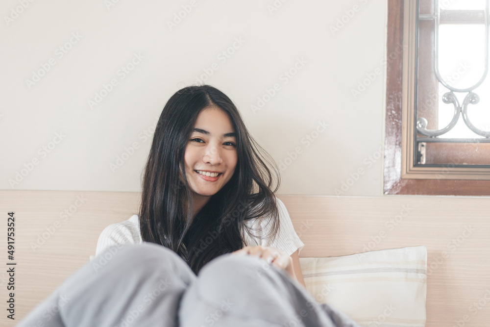 Portrait young adult asian pretty woman after wake up in morning with sunlight Portrait young adult asian pretty woman after wake up in morning with sunlight