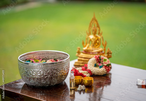 Flower garlands, water bowls, perfume and white clay filler for Buddha bathing ceremony on important religious days for Buddhists, New Year's and Songkran Festivals for Asians.
