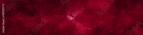Old scratched bright red paint surface wide texture. Dark scarlet color gloomy grunge abstract widescreen background. old vintage textured holiday paper or wallpaper with painted elegant red colors